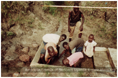 Kids at an improved spring in Adwila, Northern Uganda