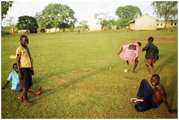 Children playing soccer in Adwila, Uganda